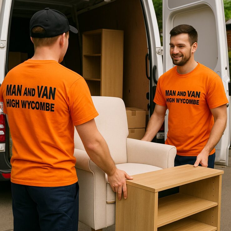Two professional movers from Man and Van High Wycombe carefully moving furniture from a white van. Both wear bright orange shirts with the company name, symbolising trust, care and efficiency in local removals.